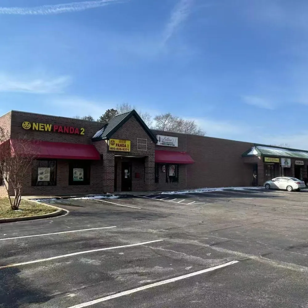 Strip mall exterior with parking at New Panda 2, a Chinese Restaurant in Gaston