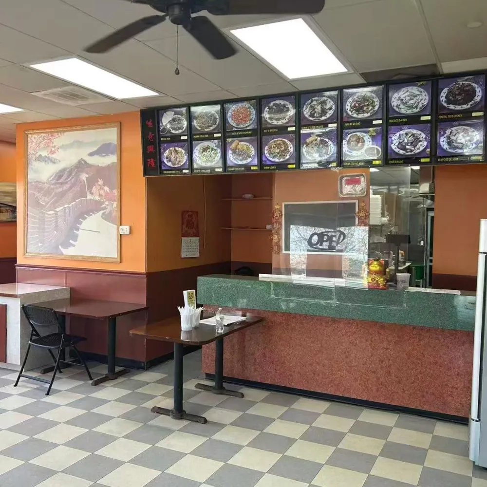 Cozy interior with menu boards and seating at New Panda 2, a Chinese Restaurant in Gaston