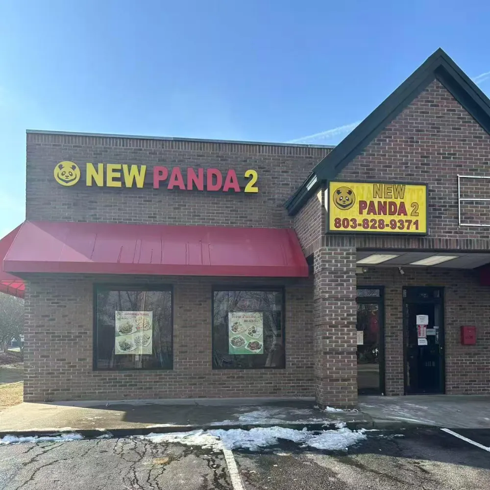 Brick exterior with red awning and signage at New Panda 2, a Chinese Restaurant in Gaston